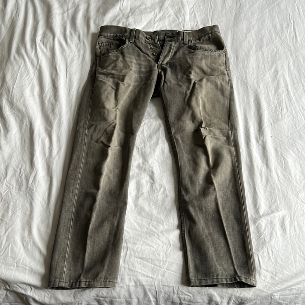 Faded pre-torn gray jeans